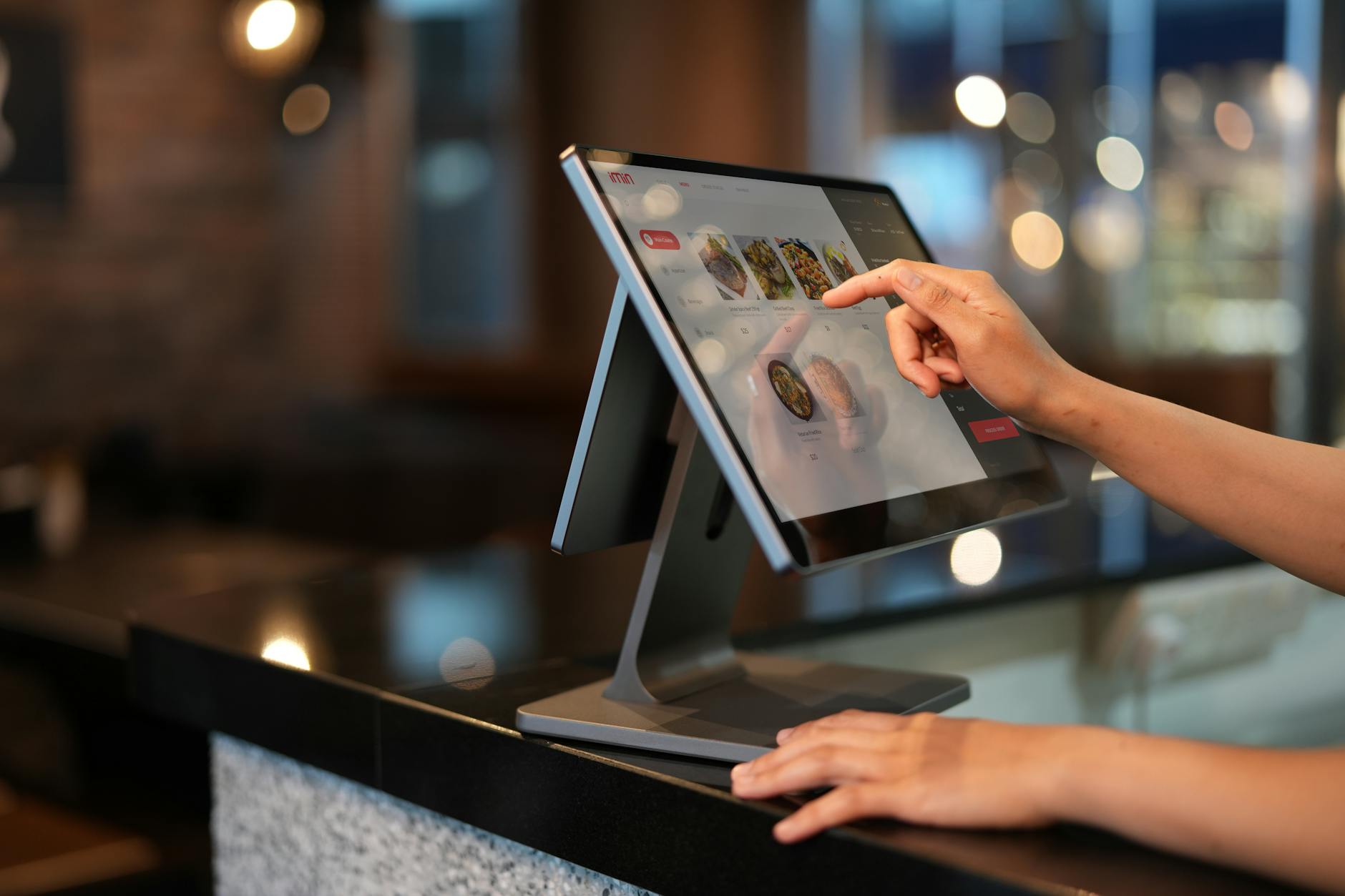 a close up shot of a cashier using a point of sale system