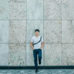 Man Standing Behind Concrete Establishment